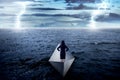 Asian business woman standing alone on the paper boat Royalty Free Stock Photo