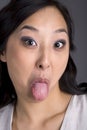 Asian Business Woman in Suit Tongue Out