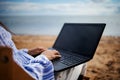 Asian business woman with tablet computer during tropical beach vacation. Freelancer working on laptop lying on sun lounger. Royalty Free Stock Photo