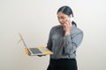 Asian business woman talking telephone with hand holding laptop Royalty Free Stock Photo