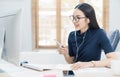 Asian business woman talking to her colleagues about plan in video conference. Business team using computer for a online meeting i Royalty Free Stock Photo