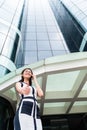 Asian business woman telephoning outside with phone