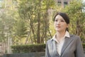 Asian business woman thinking in the city Royalty Free Stock Photo