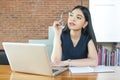 Asian Woman Thinking and Working in modern office