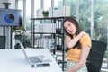 Asian business woman is tired, fatigued and has shoulder pain from using the computer for a long time