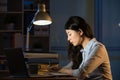 Asian business woman use laptop working overtime late night