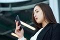 Asian Business woman using mobile phone. Portrait of beautiful girl in office or meeting room Royalty Free Stock Photo