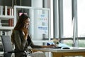 Asian business woman using mobile phone with serious  feeling in office room Royalty Free Stock Photo