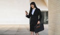 Asian business woman using mobile smartphone out the office Royalty Free Stock Photo