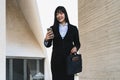 Asian business woman using mobile smartphone out the office Royalty Free Stock Photo
