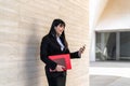 Asian business woman using mobile smartphone out the office Royalty Free Stock Photo