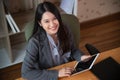 Asian business woman using tablet computer at home office Royalty Free Stock Photo