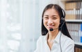 Asian business woman wear headset and working on telemarketing with online customer support.