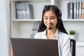 Asian business woman wear headset and working on telemarketing with online customer support. Royalty Free Stock Photo