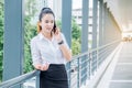 Asian business woman wearing white shirt talking smartphone for Royalty Free Stock Photo