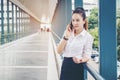 Asian business woman wearing white shirt talking smartphone for Royalty Free Stock Photo