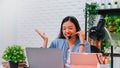 Asian business woman work from home with laptop computer and tablet on table with meeting online and video conferencing.Concept of Royalty Free Stock Photo