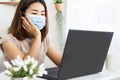 Asian business woman work from home office wearing protective mask using laptop Royalty Free Stock Photo
