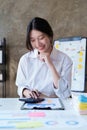 Asian Business woman working at home office and analyze financial report document. Accounting and Finance concept Royalty Free Stock Photo