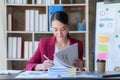 Asian Business woman working at home office and analyze financial report document. Accounting and Finance concept Royalty Free Stock Photo