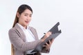 Asian business women writing documents On the clipboard in hand while working at home Royalty Free Stock Photo