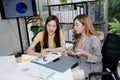 2 Asian business women attractive and young are consulting, analyzing plans Royalty Free Stock Photo