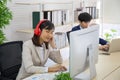 Asian business women listening to music from headphones in the office Royalty Free Stock Photo