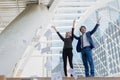 Asian businessman and businesswoman throwing paper in the air and raising up two hands to celebrated for successful in mission Royalty Free Stock Photo