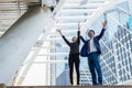 Asian businessman and businesswoman throwing paper in the air and raising up two hands to celebrated for successful success Royalty Free Stock Photo