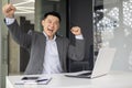 Asian businessman celebrating success in office Royalty Free Stock Photo