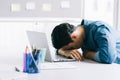 Asian businessman is falling asleep on his desk from overwork Royalty Free Stock Photo