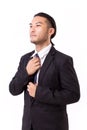 Asian businessman fastening his necktie Royalty Free Stock Photo