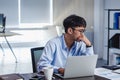 Asian businessman get stress and thinking when working with laptop on desk at modern office.business fail concept.man rest hand on Royalty Free Stock Photo