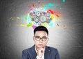 Asian businessman in glasses, brain gears Royalty Free Stock Photo