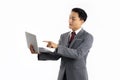 Asian businessman in grey suit white shirt red tie toching and pointing on notbook screen white background