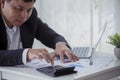 Asian businessman hands calculating number, graph, chart audit planning accountancy on business report. Asian professional