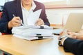 Asian businessman and his assistant Secretary signing document work in office. Royalty Free Stock Photo