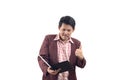 Asian businessman hold tablet and showing thumb up with smile is Royalty Free Stock Photo