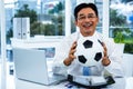 Asian businessman holding soccer ball Royalty Free Stock Photo