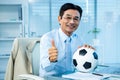 Asian businessman holding soccer ball with thumps up Royalty Free Stock Photo