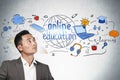 Asian businessman looks at online education icons Royalty Free Stock Photo