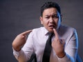 Asian Businessman Pointing Himself with Unhappy Expression as if he confused to be accused