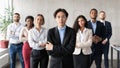 Asian Businessman Posing Standing With His Employees Team In Office Royalty Free Stock Photo