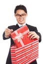 Asian businessman pull gift box from shopping bag Royalty Free Stock Photo