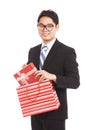 Asian businessman pull gift box from shopping bag Royalty Free Stock Photo