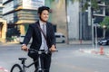 Asian businessman pushing his bicycle from home in the morning preparing to ride his bicycle to work. Eco tranportation Royalty Free Stock Photo