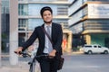 Asian businessman pushing his bicycle from home in the morning preparing to ride his bicycle to work. Eco tranportation Royalty Free Stock Photo