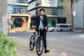 Asian businessman pushing his bicycle from home in the morning preparing to ride his bicycle to work. Eco tranportation Royalty Free Stock Photo