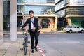 Asian businessman pushing his bicycle from home in the morning preparing to ride his bicycle to work. Eco tranportation Royalty Free Stock Photo