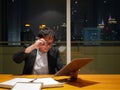 Asian businessman review brief document after work in meeting room